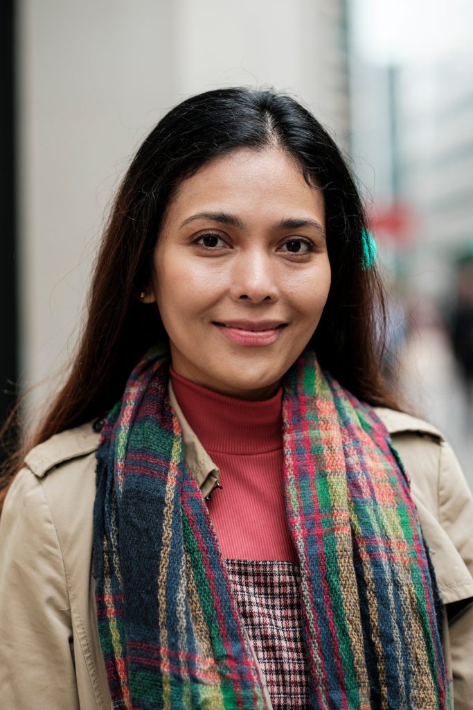 multicultural-woman-smiling-wearing-a-scarf-and-tr-2026-03-11-23-28-59-utc (1)
